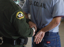 Image of inmate being handcuffed